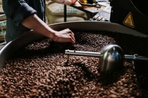 roaster tending to coffee beans