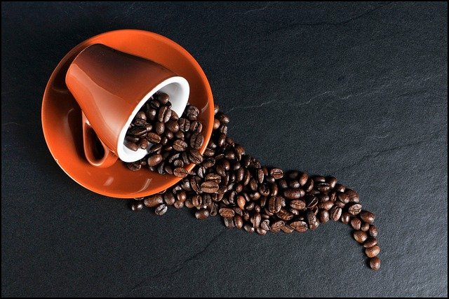 robusta beans in coffee mug laying on side